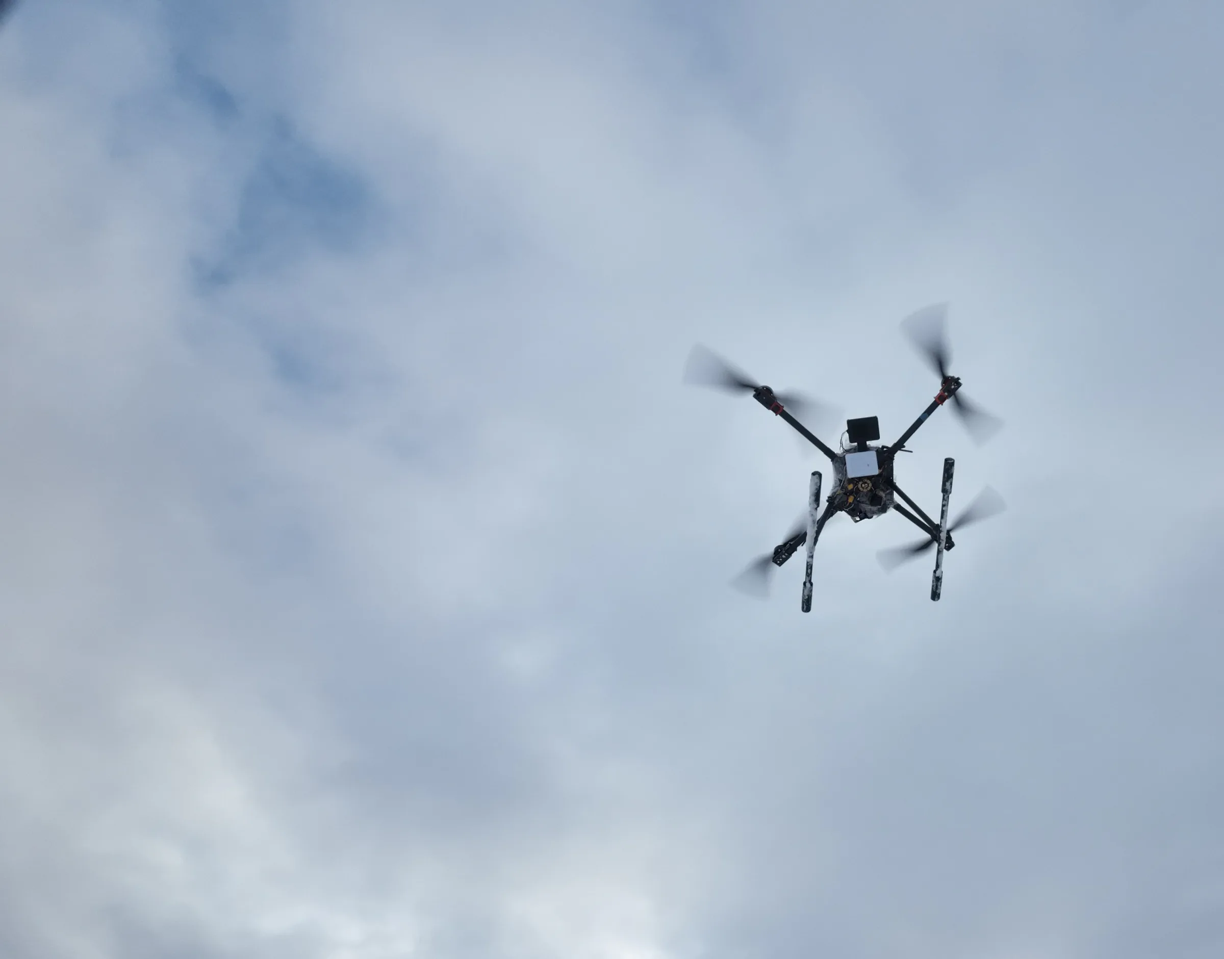 A Rosor survey drone in flight against overcast winter cloud